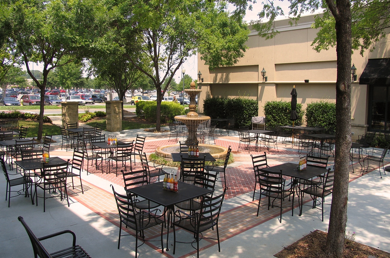 Stonecrest Shopping Center looked to SCOPE to provide plaza designs that would enhance two unique outdoor spaces. This image showcases the additional seating, landscaping and creative brick and concrete patterned flooring.