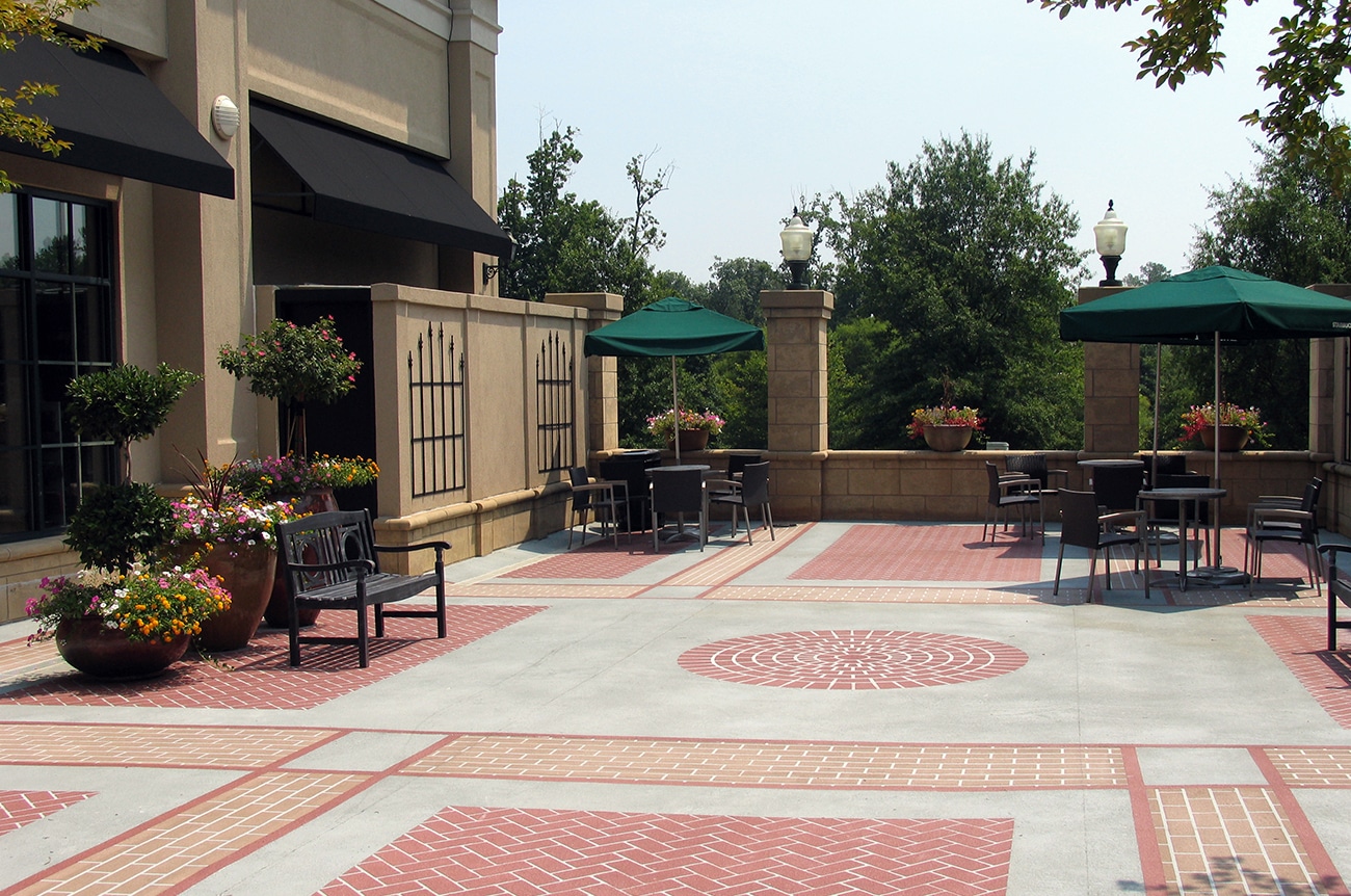 Stonecrest Shopping Center looked to SCOPE to provide plaza designs that would enhance two unique outdoor spaces. This image showcases the additional seating, landscaping and creative brick and concrete patterned flooring.